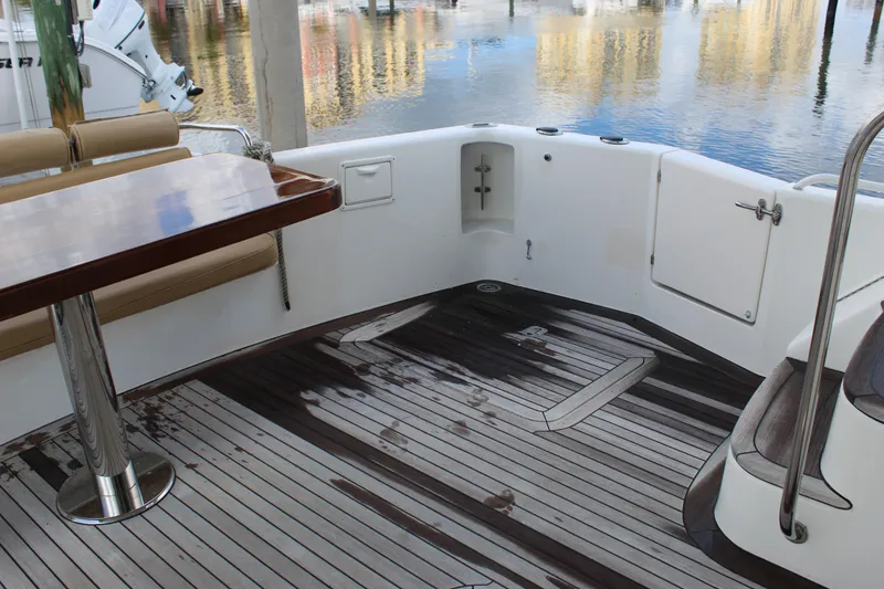 Slide: The Image of 2003 Ocean Yachts 65 Odyssey deck with wooden flooring and seating area. - 94