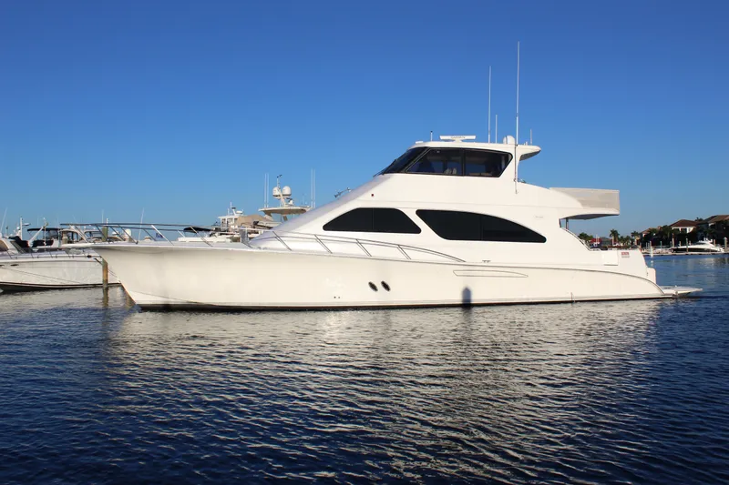 The Image of 2003 Ocean Yachts 65 Odyssey in marina, sleek design, calm waters, clear blue sky. - 0