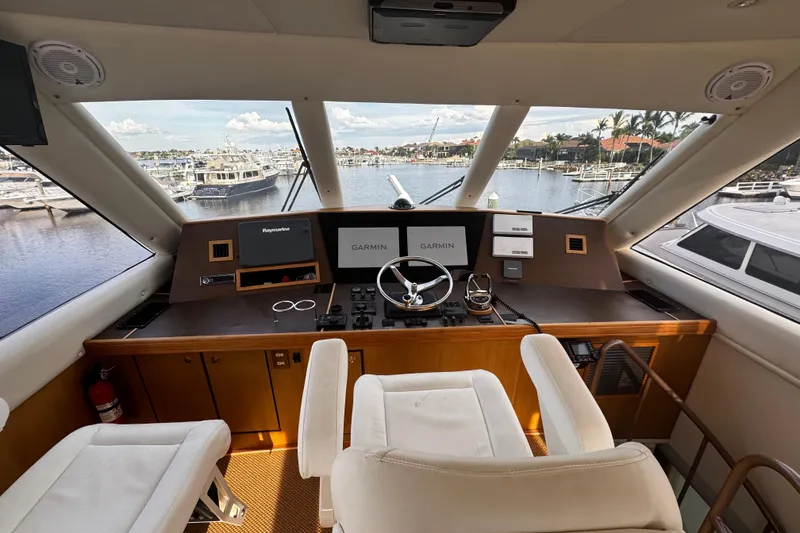 Slide: The Image of Cockpit of 2003 Ocean Yachts 65 Odyssey with navigation equipment and marina view. - 19