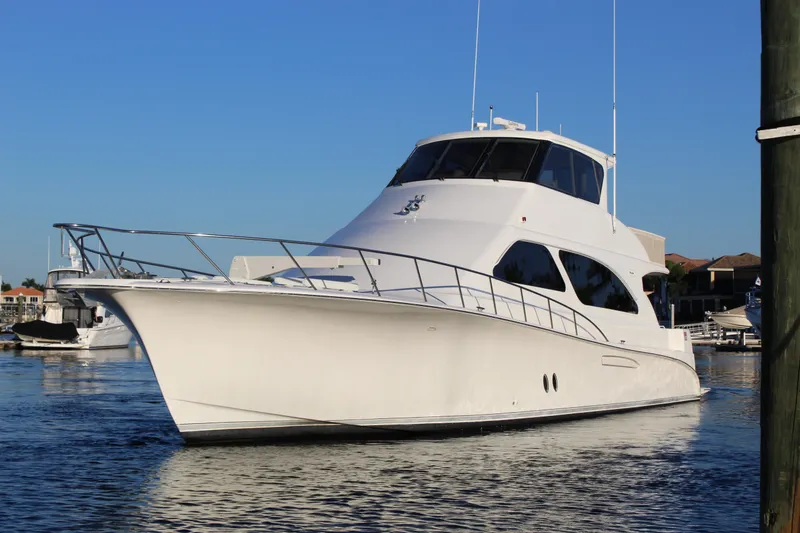 Slide: The Image of Luxury 2003 Ocean Yachts 65 Odyssey cruising in a serene marina setting. - 2