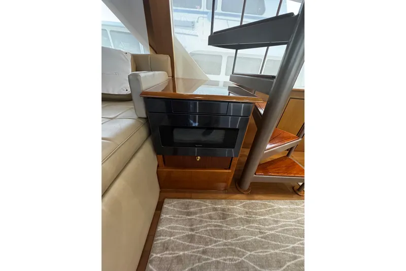 Slide: The Image of Interior of 2003 Ocean Yachts 65 Odyssey with spiral staircase and modern seating. - 26