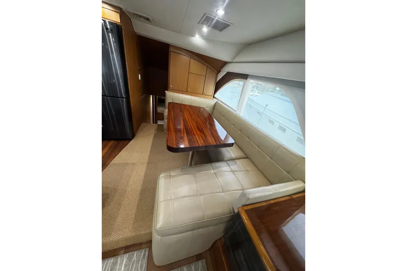 Slide: The Image of Luxurious interior of 2003 Ocean Yachts 65 Odyssey with elegant dining area and plush seating. - 28