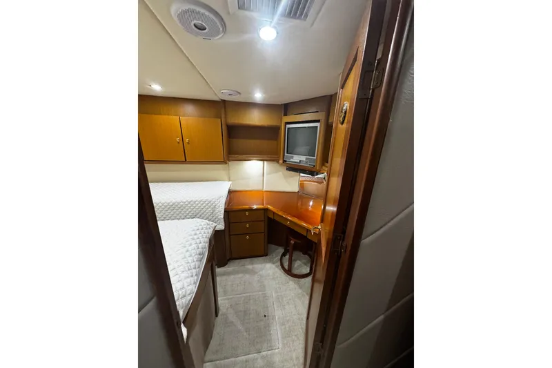 Slide: The Image of Interior cabin of 2003 Ocean Yachts 65 Odyssey, featuring wood cabinetry and a small desk. - 30