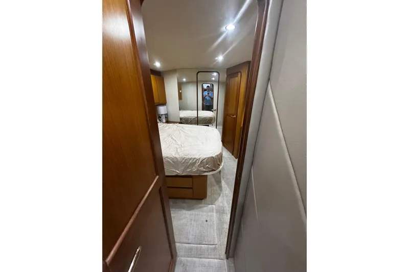 Slide: The Image of Interior cabin of 2003 Ocean Yachts 65 Odyssey with bed and wooden accents. - 31
