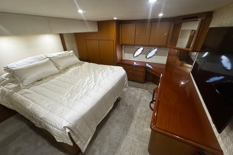 Slide: The Image of Luxurious bedroom interior of 2003 Ocean Yachts 65 Odyssey with elegant wood finishes. - 33