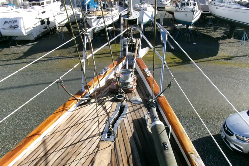 Slide: The Image of 1980 Ketch 51 sailboat on dry dock, showcasing deck and rigging details. - 10