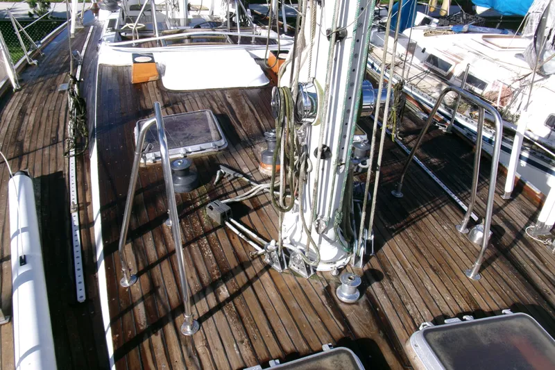 Slide: The Image of 1980 Ketch 51 sailboat deck with wooden finish and rigging details. - 11