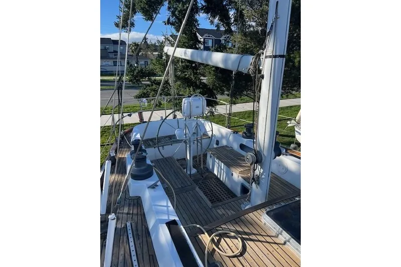 Slide: The Image of 1980 Ketch Alden sailboat deck with wooden flooring and rigging. - 14