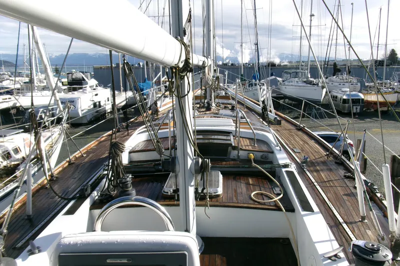 Slide: The Image of 1980 Ketch 51 sailboat with wooden deck, docked in a marina. - 15