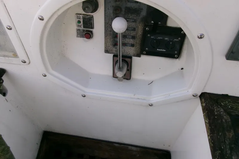 Slide: The Image of Control panel of a 1980 Ketch 51 boat, featuring levers and switches. - 16