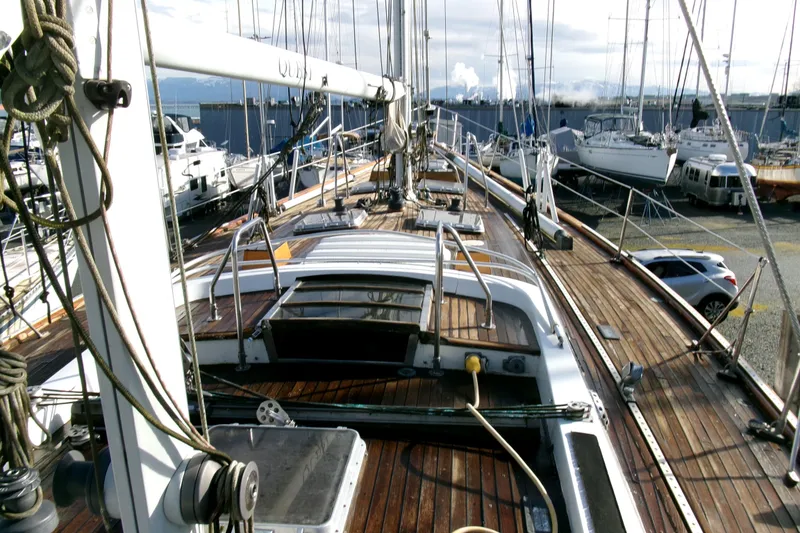 Slide: The Image of 1980 Ketch 51 sailboat with wooden deck, docked in a marina. - 18