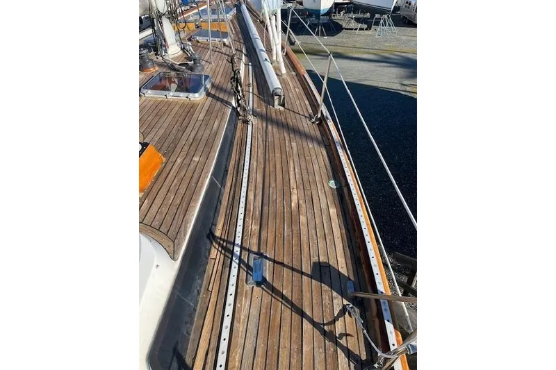 Slide: The Image of 1980 Ketch Alden sailboat deck with wooden finish and rigging details. - 4