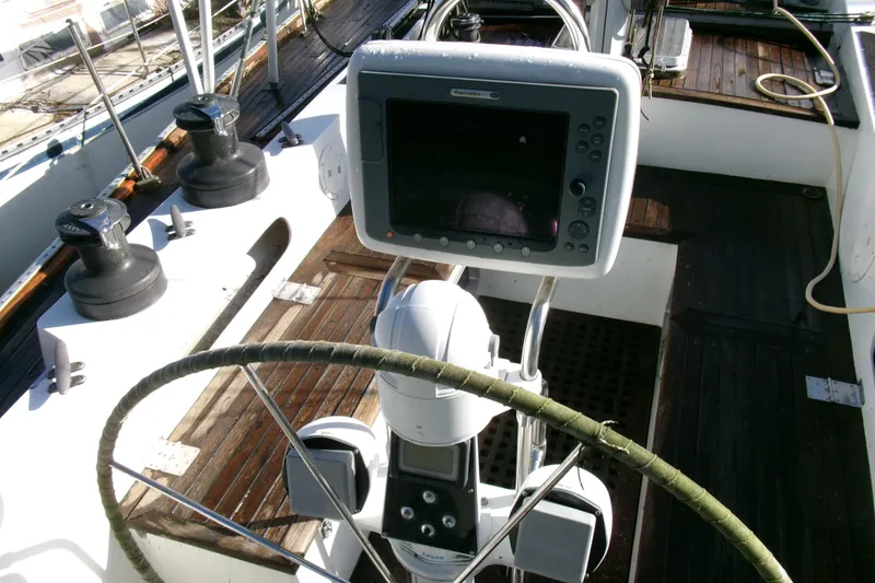 Slide: The Image of Cockpit of 1980 Ketch 51 sailboat with navigation equipment and steering wheel. - 13
