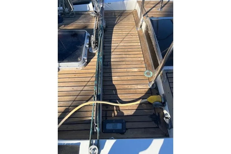 Slide: The Image of Wooden deck of 1980 Ketch Alden sailboat with ropes and hatch. - 5