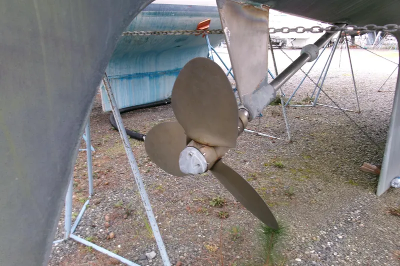 Slide: The Image of Propeller of 1980 Ketch 51 sailboat on dry dock, showing metal blades and shaft. - 6