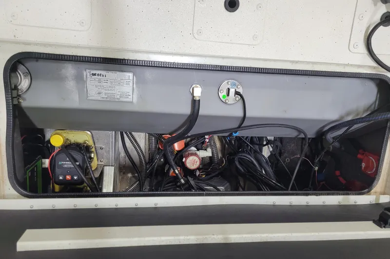 Slide: The Image of 2024 Ranger RB210 boat engine compartment with wiring and components visible. - 10
