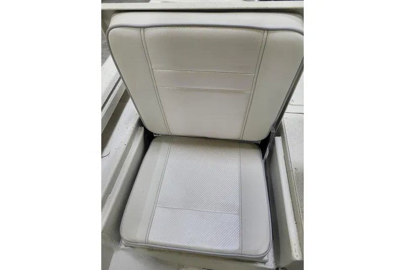 Slide: The Image of 2024 Ranger RB210 boat seat with white cushioned upholstery. - 15