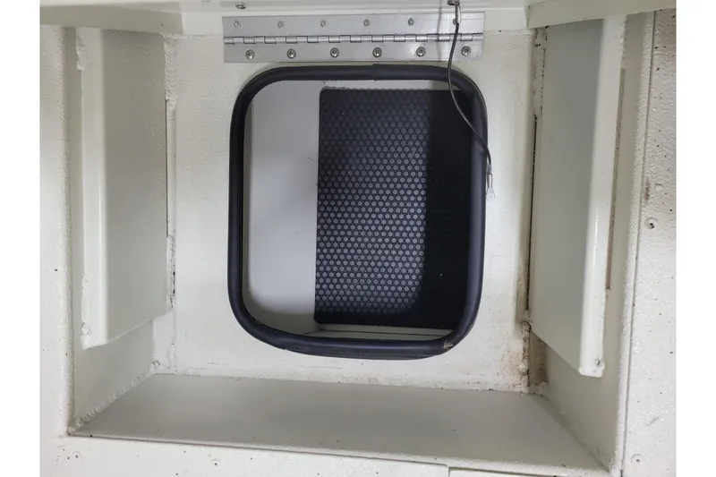 Slide: The Image of 2024 Ranger RB210 storage compartment with hinged lid and textured interior. - 17