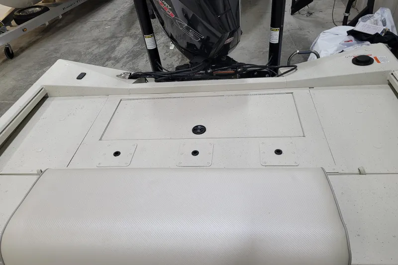 Slide: The Image of 2024 Ranger RB210 boat deck with motor, featuring storage compartments. - 19