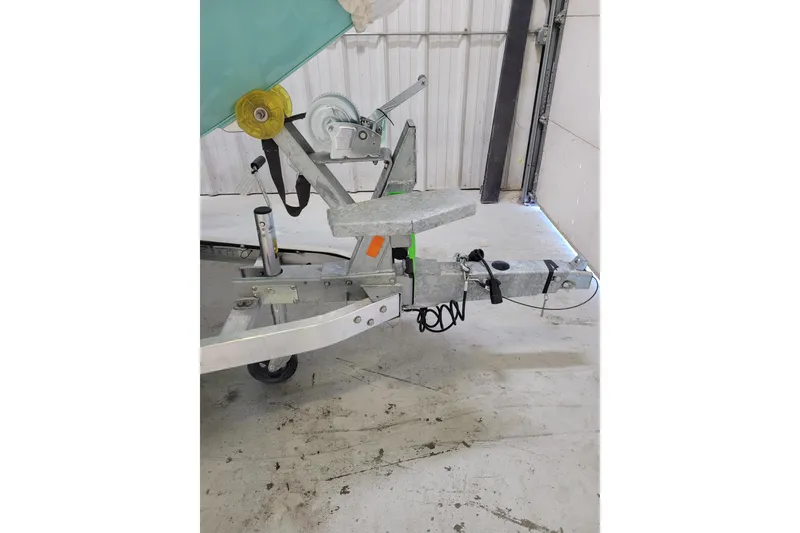 Slide: The Image of 2024 Ranger RB210 boat trailer with winch and hitch in a garage setting. - 23