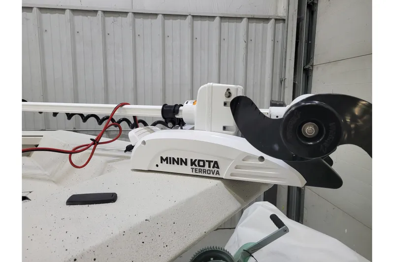 Slide: The Image of 2024 Ranger RB210 with Minn Kota Terrova trolling motor in a garage setting. - 27