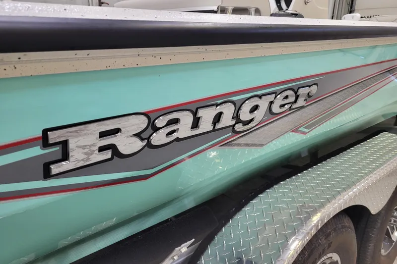 Slide: The Image of 2024 Ranger RB210 boat with teal and silver detailing, featuring bold branding. - 28