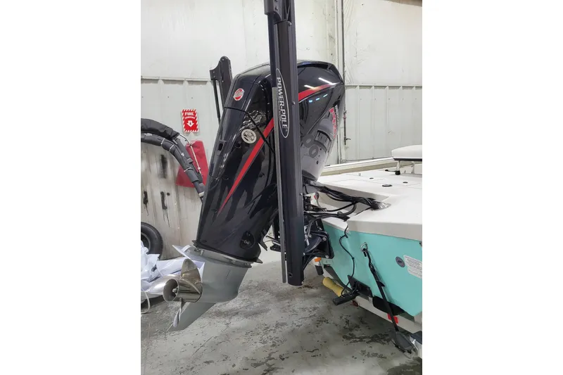 Slide: The Image of 2024 Ranger RB210 boat with powerful outboard motor in a workshop setting. - 29