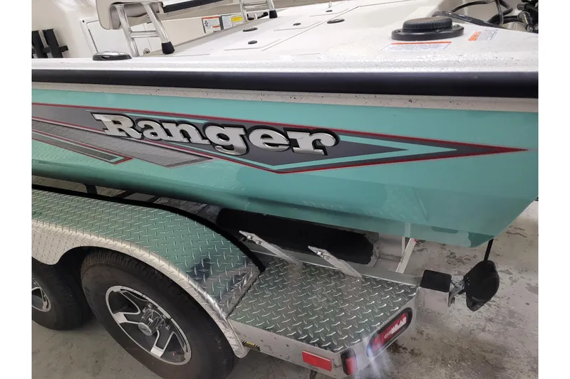 Slide: The Image of 2024 Ranger RB210 boat on a trailer, showcasing sleek design and vibrant color. - 31