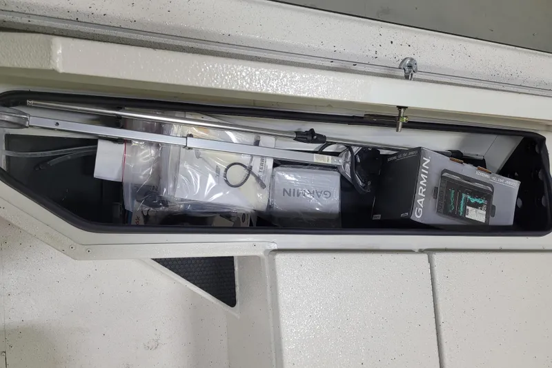Slide: The Image of 2024 Ranger RB210 storage compartment with Garmin electronics and accessories. - 4