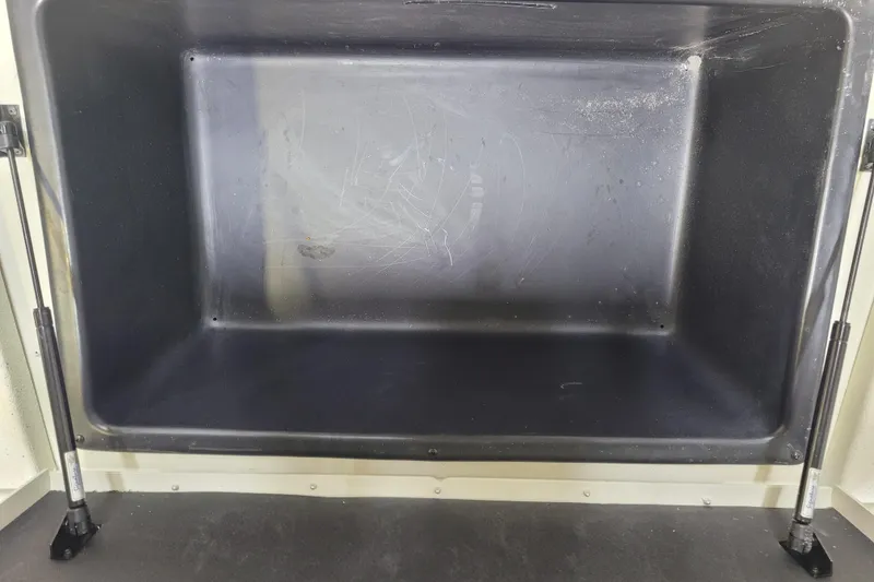 Slide: The Image of Open storage compartment of 2024 Ranger RB210, featuring hydraulic supports. - 6