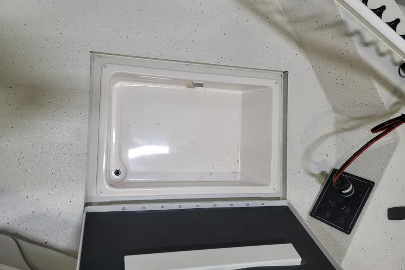 Slide: The Image of 2024 Ranger RB210 boat compartment with wiring and control panel. - 8