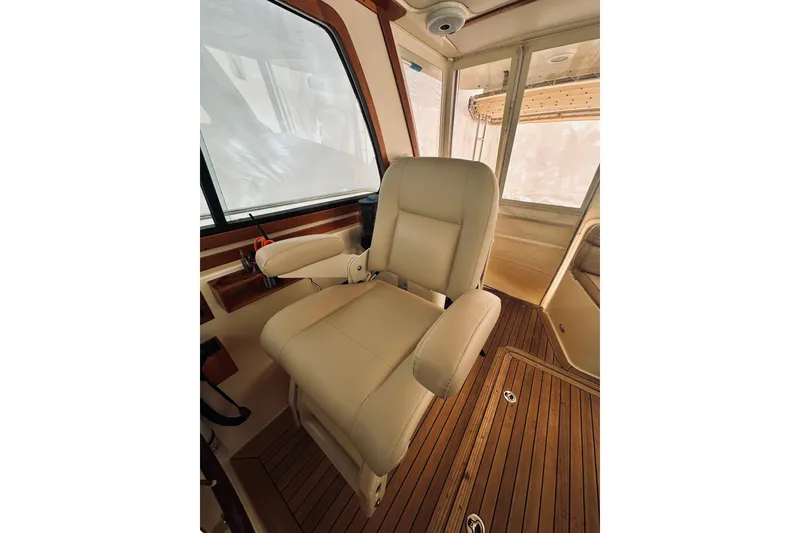 Slide: The Image of 2008 Sabre 38 Hard Top Express interior with wood accents and helm station. - 10