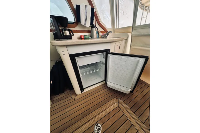 Slide: The Image of 2008 Sabre 38 Hard Top Express helm with leather seat and wooden steering wheel. - 12