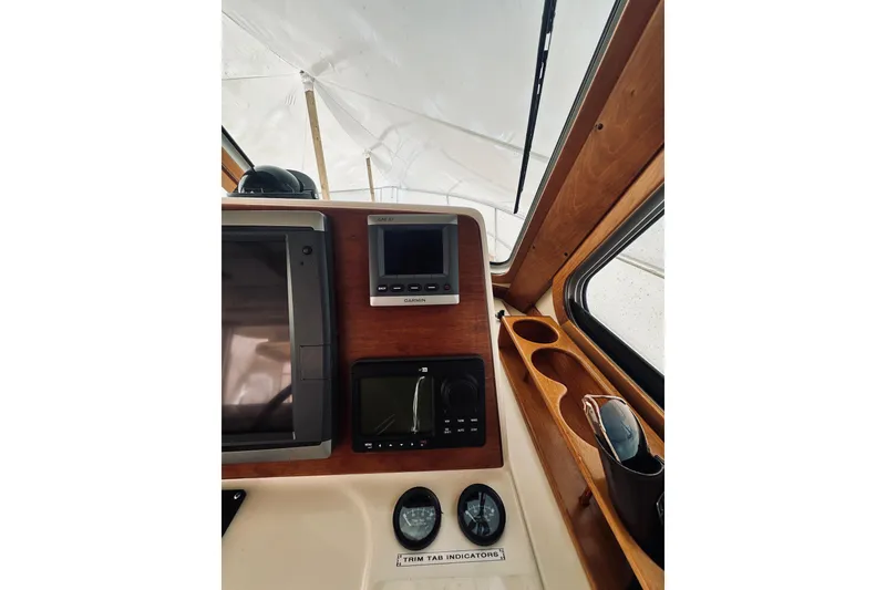 Slide: The Image of 2008 Sabre 38 Hard Top Express helm with steering wheel and navigation equipment. - 16
