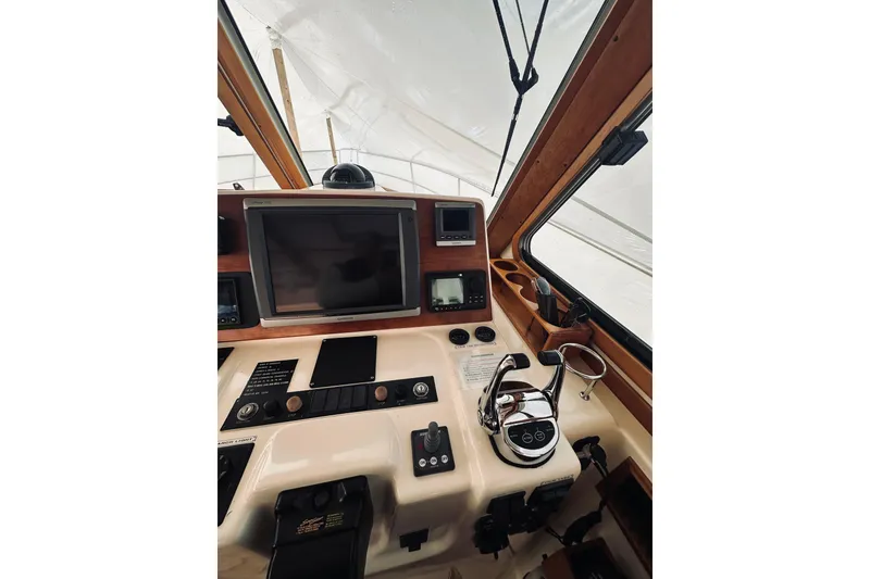 Slide: The Image of 2008 Sabre 38 Hard Top Express helm with navigation instruments and controls. - 17