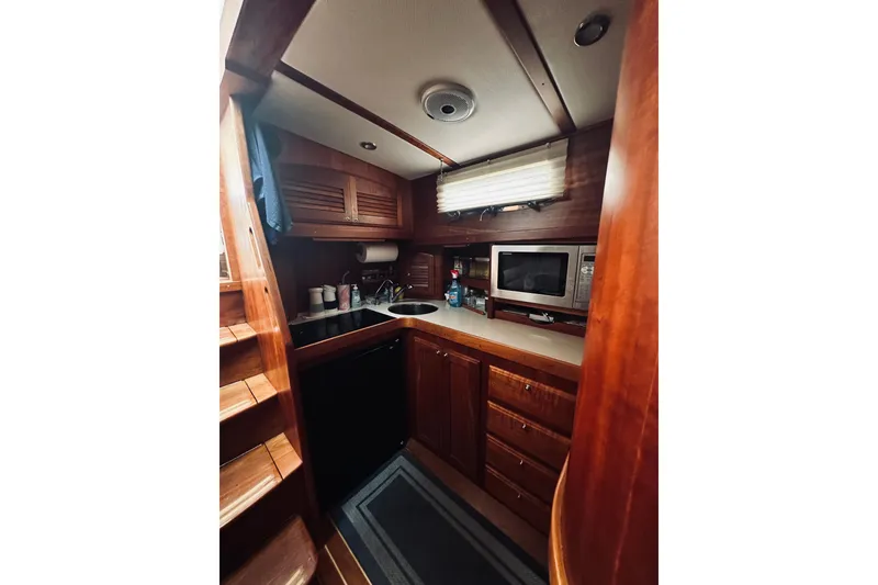 Slide: The Image of Interior of 2008 Sabre 38 Hard Top Express yacht with wooden finishes and cozy seating. - 36
