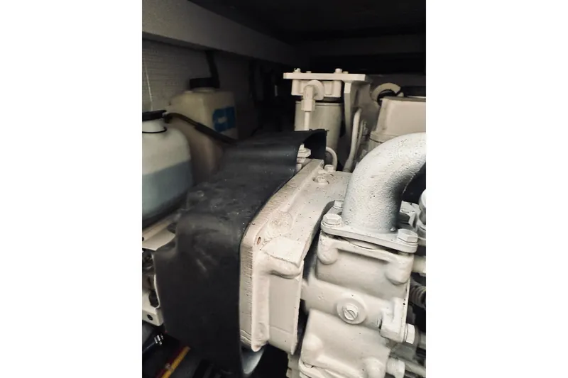 Slide: The Image of Engine room of 2008 Sabre 38 Hard Top Express with visible hoses and components. - 48