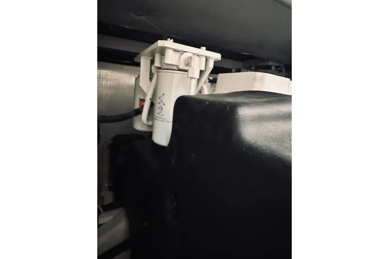 Slide: The Image of Engine compartment of a 2008 Sabre 38 Hard Top Express boat, showing filters and hoses. - 59