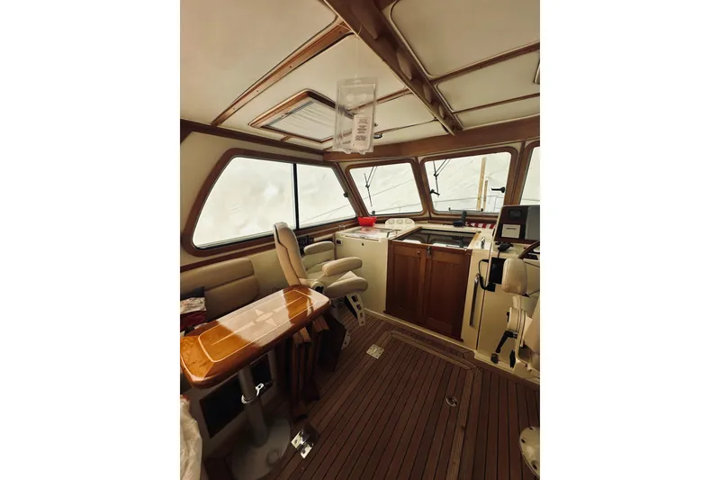 Slide: The Image of 2008 Sabre 38 Hard Top Express boat interior with beige seating and wooden flooring. - 7