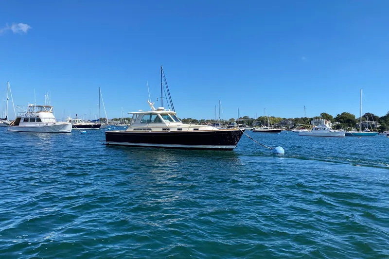 Slide: The Image of 2008 Sabre 38 Hard Top Express yacht moored in a scenic harbor. - 76