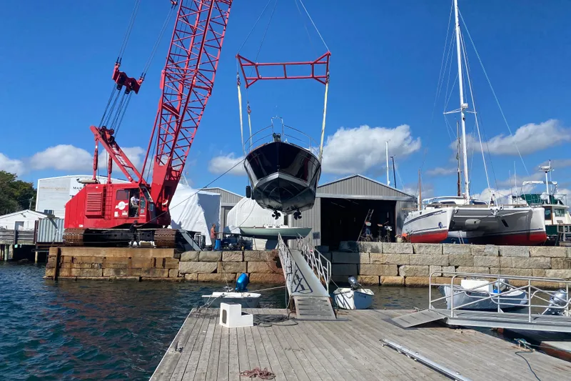Slide: The Image of 2008 Sabre 38 Hard Top Express being lifted by crane at marina dock. - 77