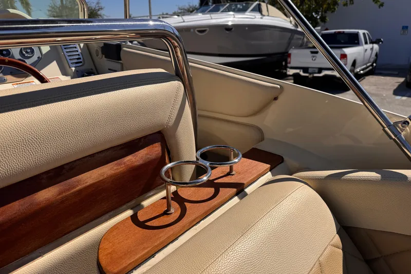 Slide: The Image of 2019 Chris-Craft Corsair 30 interior with beige leather seats and cup holders. - 10