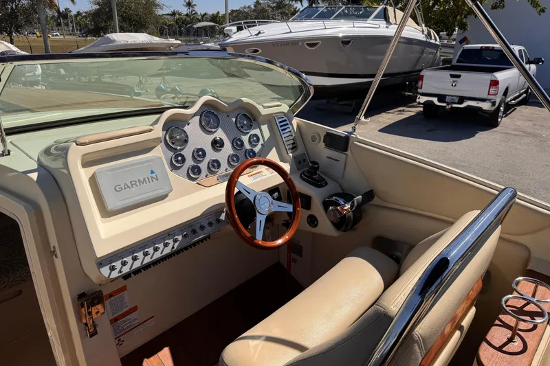 Slide: The Image of 2019 Chris-Craft Corsair 30 boat dashboard with Garmin navigation system and leather seating. - 11