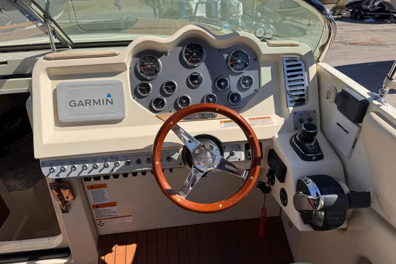 Slide: The Image of 2019 Chris-Craft Corsair 30 dashboard with Garmin navigation and wooden steering wheel. - 12