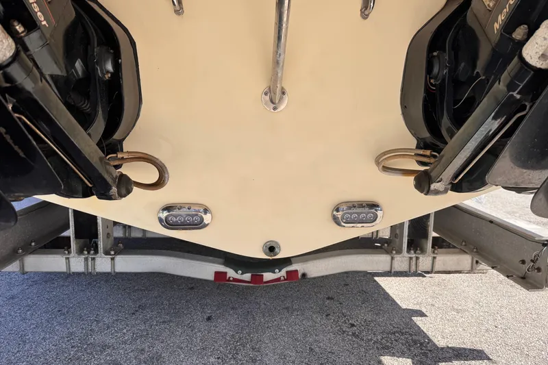 Slide: The Image of 2019 Chris-Craft Corsair 30 boat stern with dual outboard motors on trailer. - 23