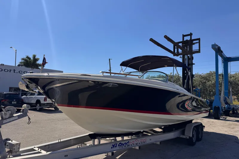 Slide: The Image of 2019 Chris-Craft Corsair 30 boat on trailer under clear blue sky. - 3