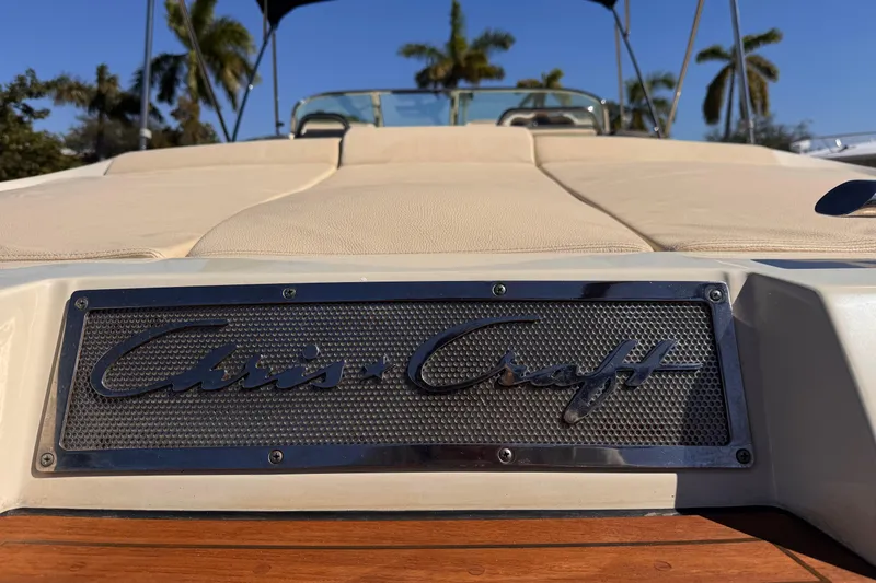 Slide: The Image of 2019 Chris-Craft Corsair 30 boat with logo, beige seating, and palm trees in background. - 5