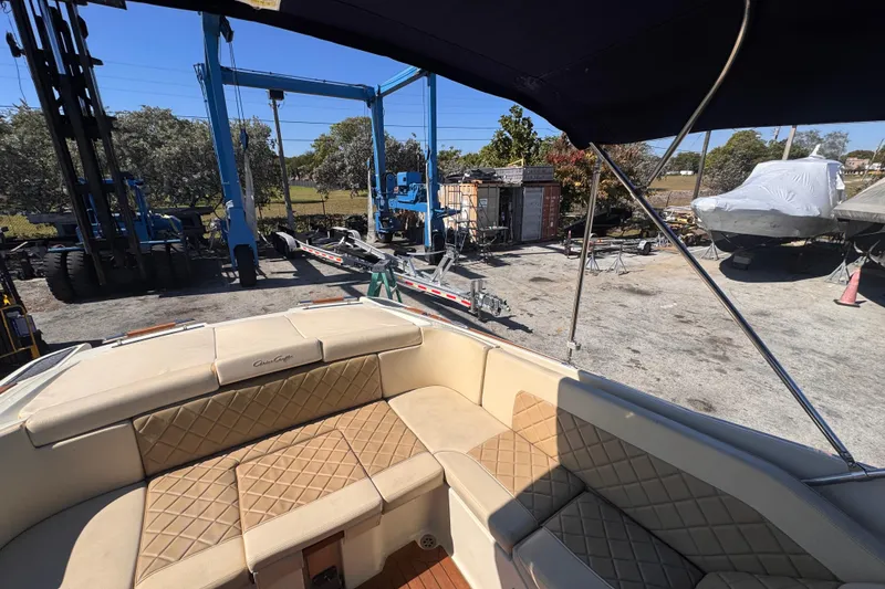 Slide: The Image of 2019 Chris-Craft Corsair 30 boat interior with tan quilted seating at a marina. - 7