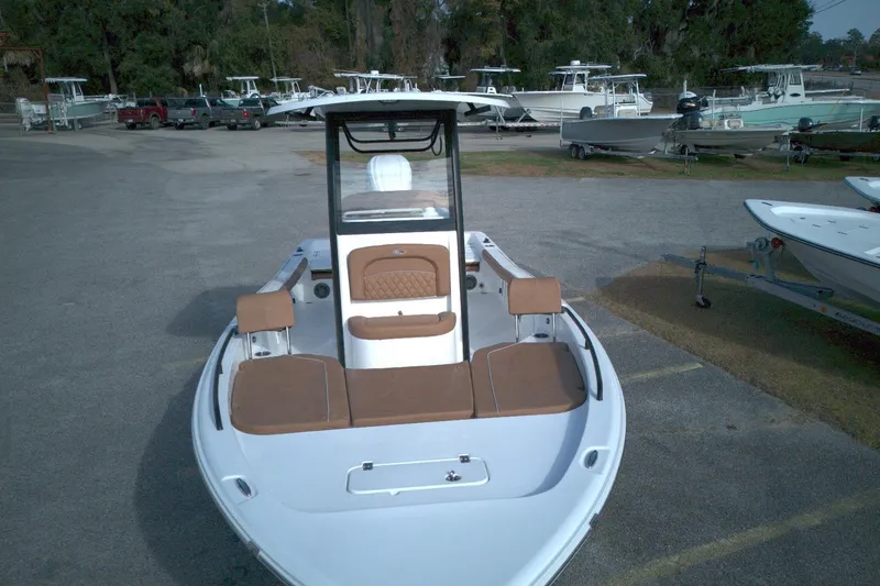 Slide: The Image of 2026 Sea Hunt BX 25 FS boat with brown seating, parked in a marina. - 2