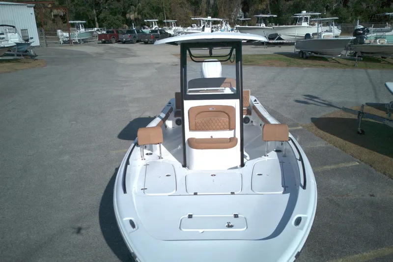 Slide: The Image of 2026 Sea Hunt BX 25 FS boat with tan seating, parked in a marina. - 6